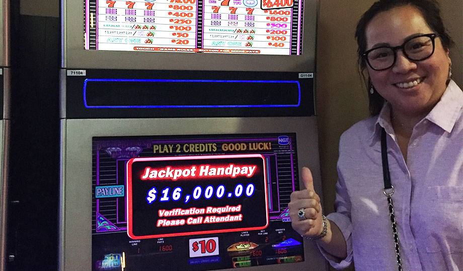 Jackpot winner Duane smiling in front of his winning video gaming machine